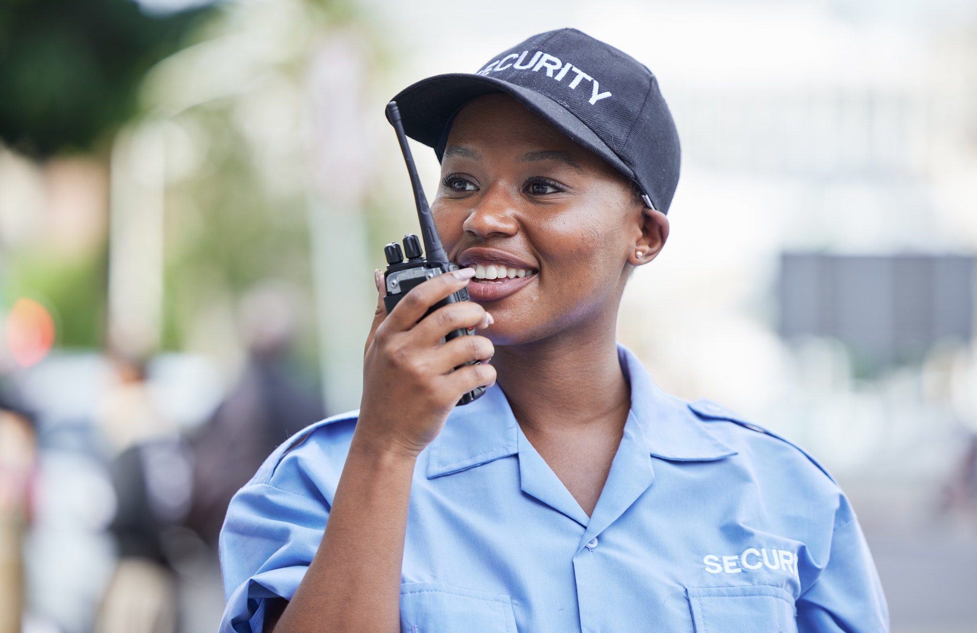 Woman, security guard and radio in street, city and communication for contact, backup or safety wit